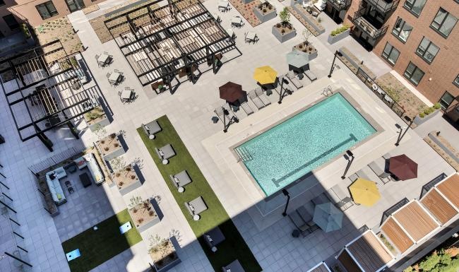 Relax and unwind poolside a pool in a courtyard