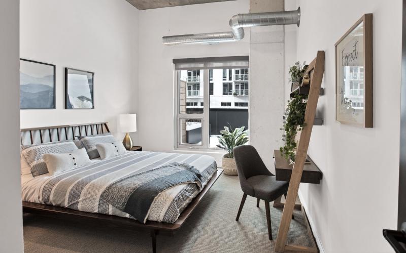 Beautiful bedrooms to fit every need a bedroom with a bed and a chair