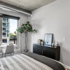 a bedroom with a bed and a chair