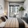 a bedroom with a bed and a plant