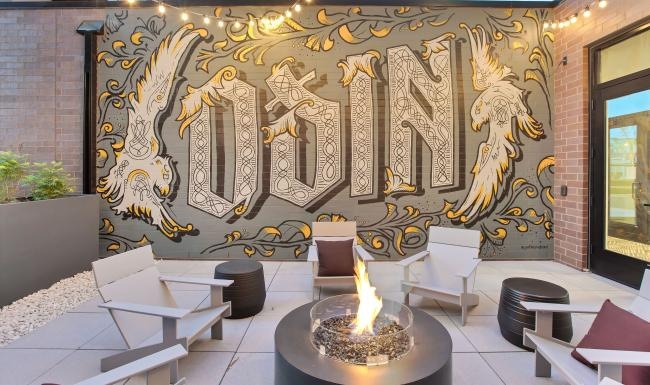 Settle into comfort at Odin firepit with chairs and a painted wall