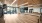 a large empty room with a wood floor and a large window