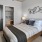 a bedroom with a bed and lamps